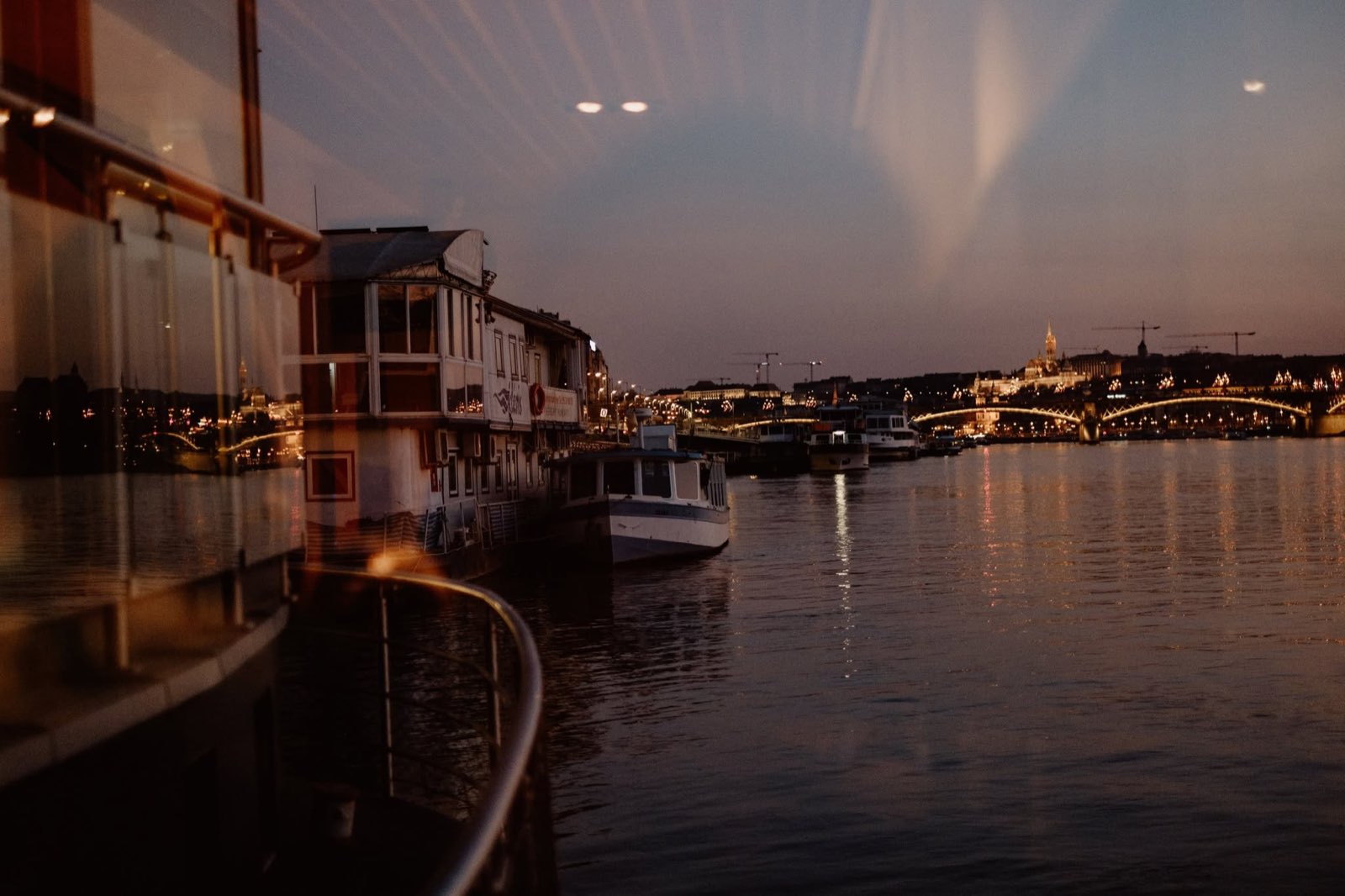 A view from the boat over the Danube and the bridge at dusk