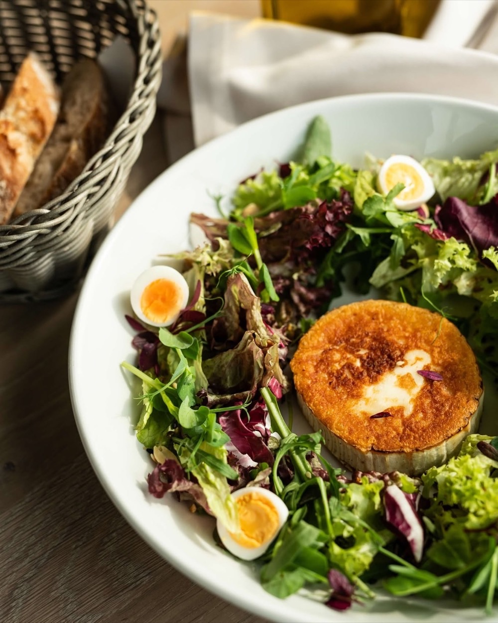 Grilled goat cheese with fresh salad and boiled egg