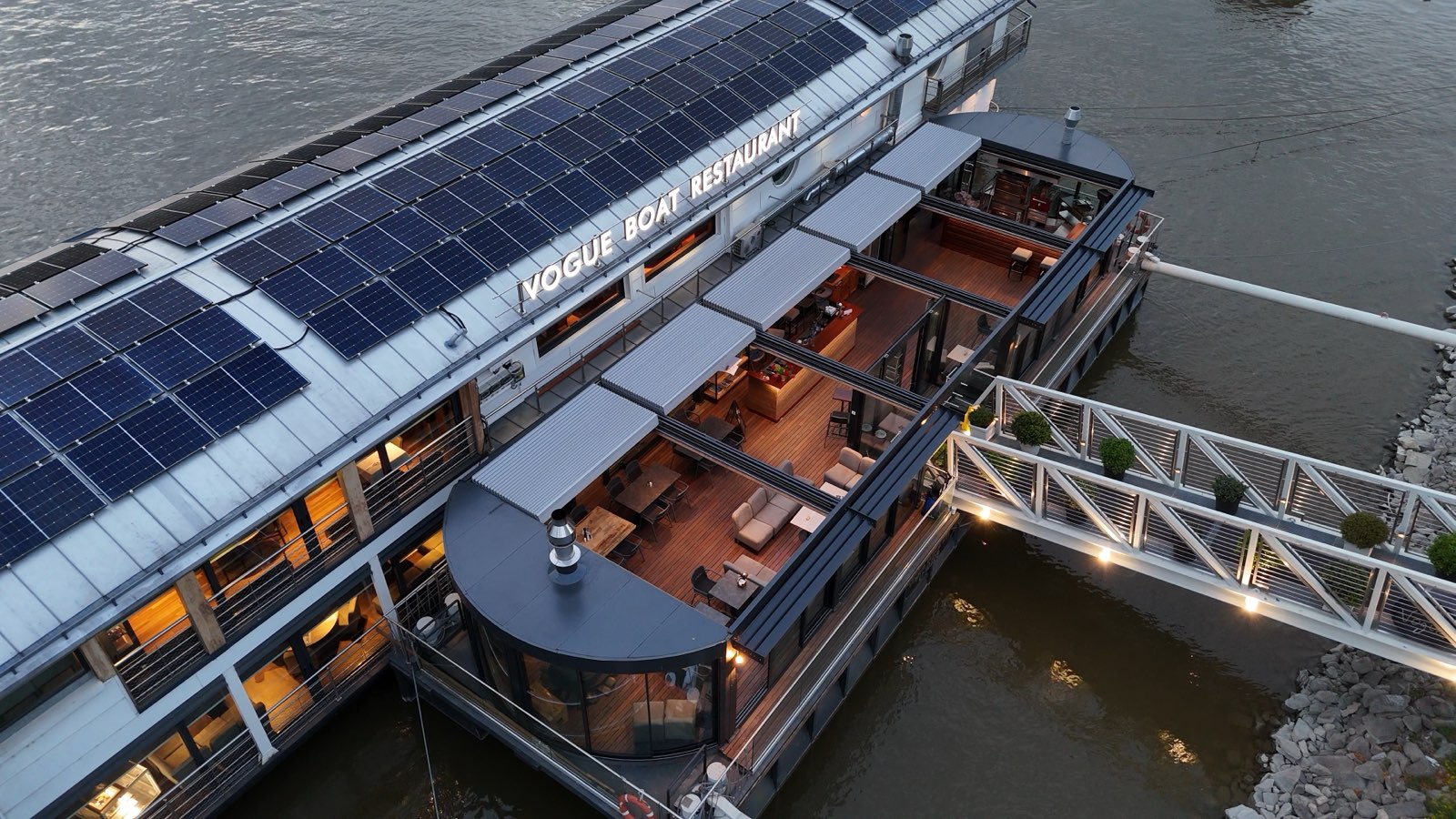 The pavilion and gangway of the boat from above at dusk