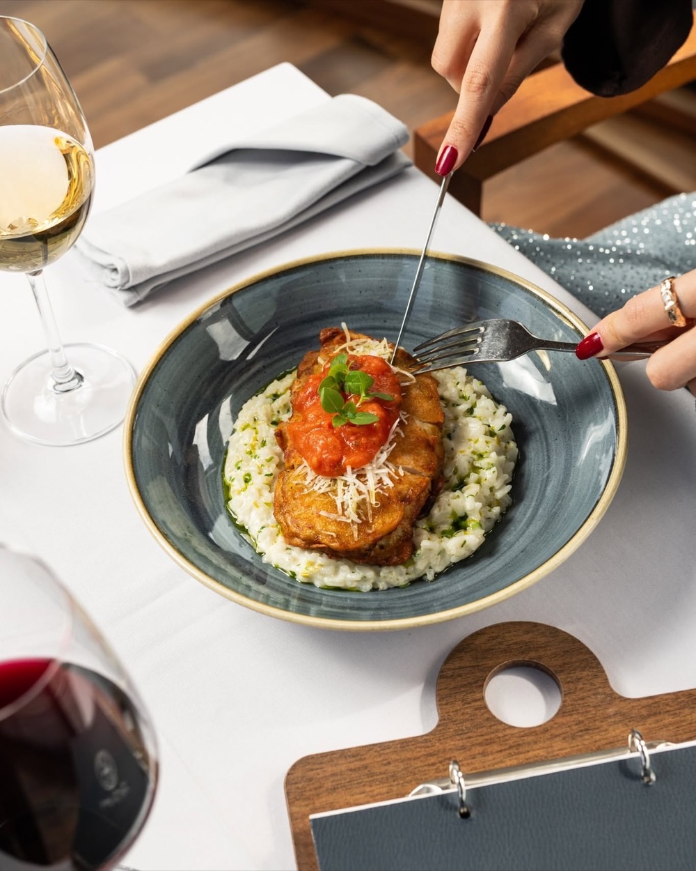 Braised meat in tomato sauce on herb risotto with parmesan
