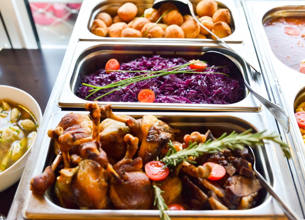 Confit duck leg and braised red cabbage in a chafing dish