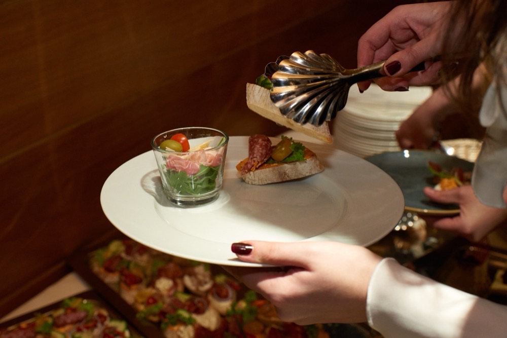 A waiter serving the cold bites