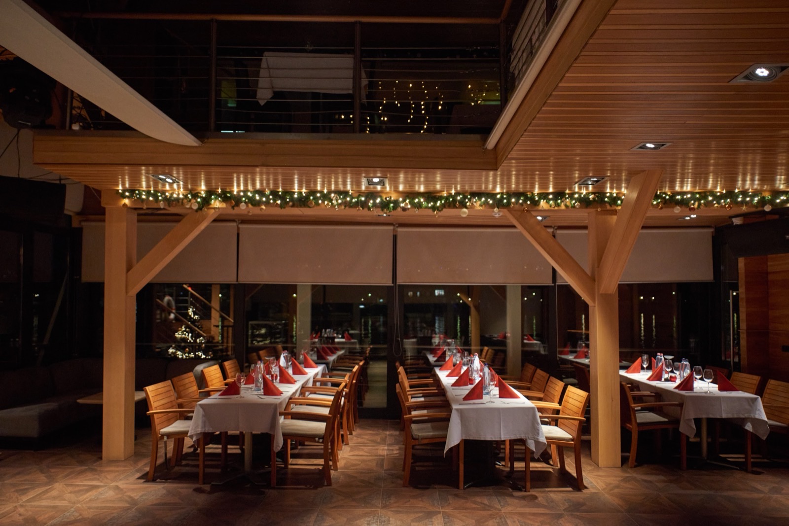 Tables laid with Christmas string lights on board