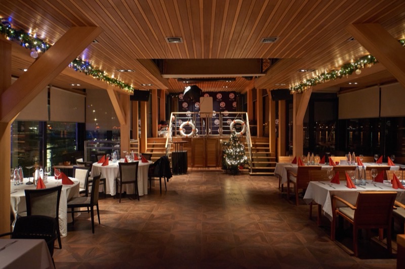 The ground-floor lounge in Christmas decoration, tables laid
